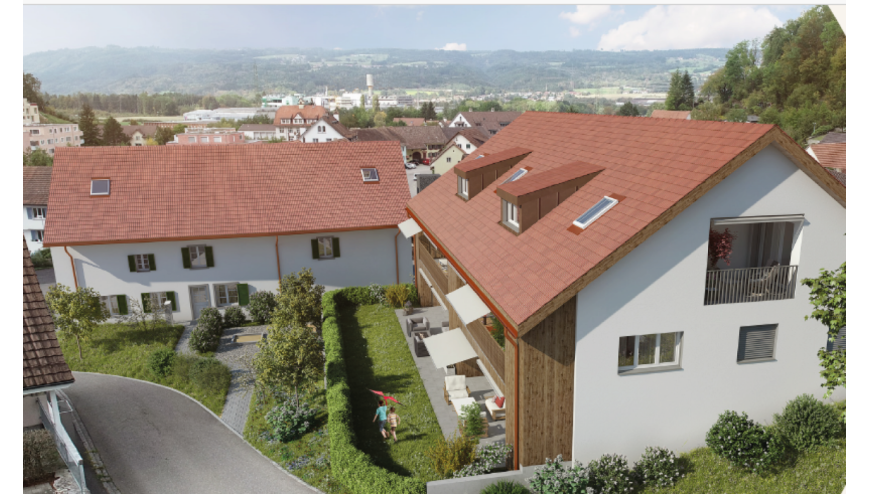 Wohnanlage mit roten Satteldächern und Talblick