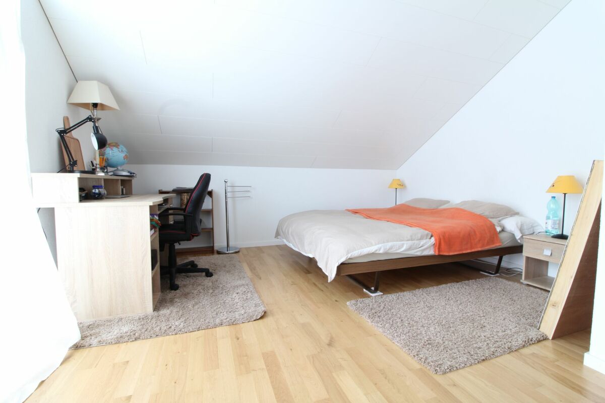 Helles Dachgeschoss-Schlafzimmer mit Arbeitsbereich