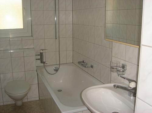 Kleines Badezimmer mit Badewanne und Waschbecken