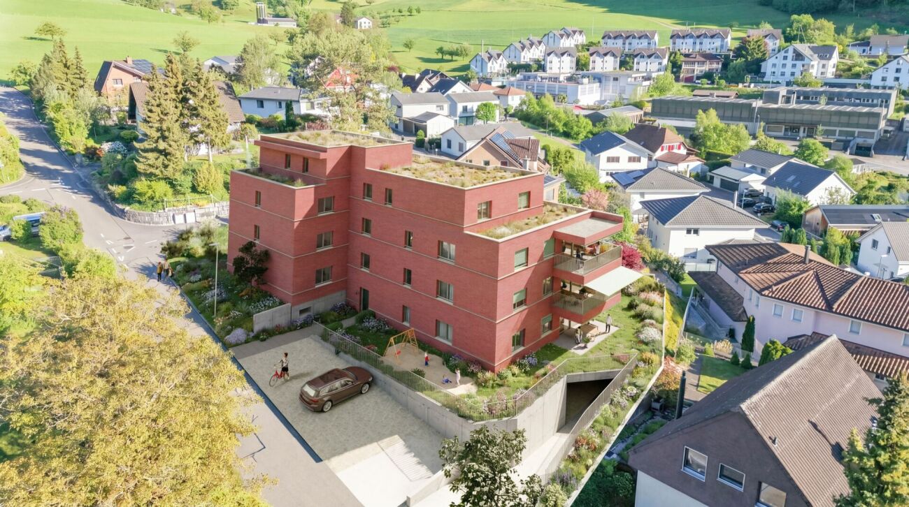 Luftaufnahme eines modernen Wohngebäudes in grüner Nachbarschaft