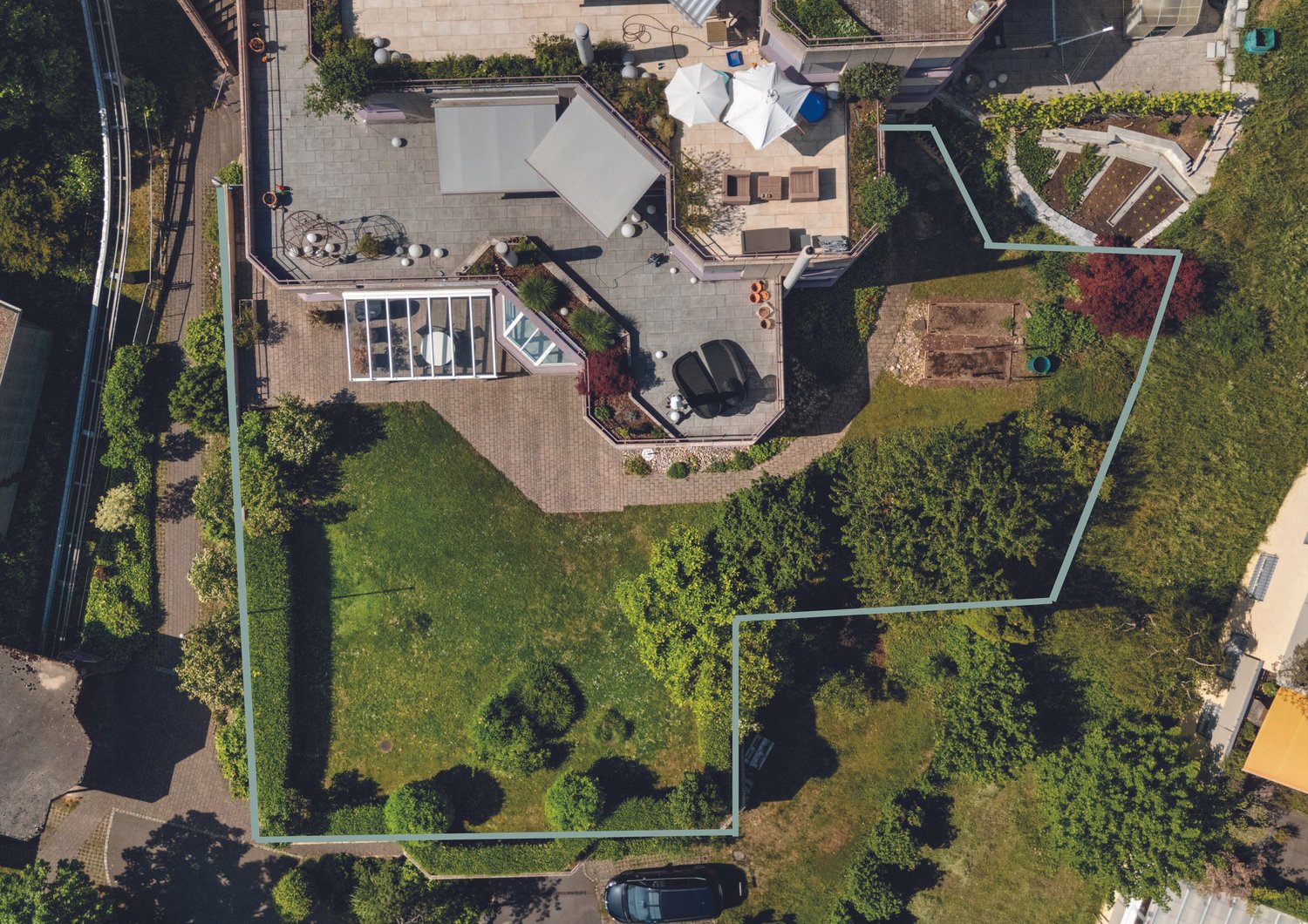 Luftaufnahme eines großen Gartengrundstücks mit Terrasse und Nebenzonen