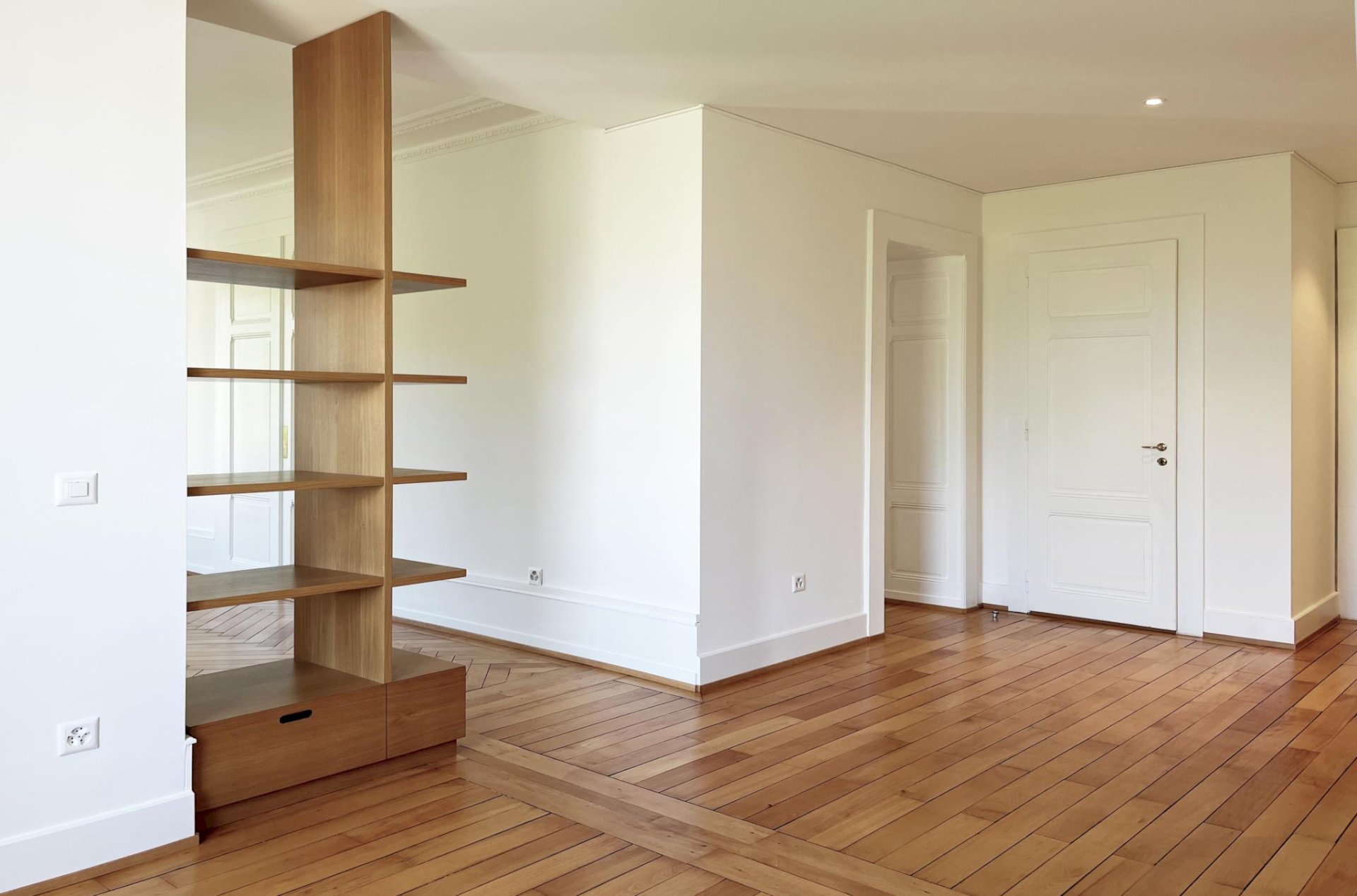 Heller Wohnraum mit Parkett und Holzregal
