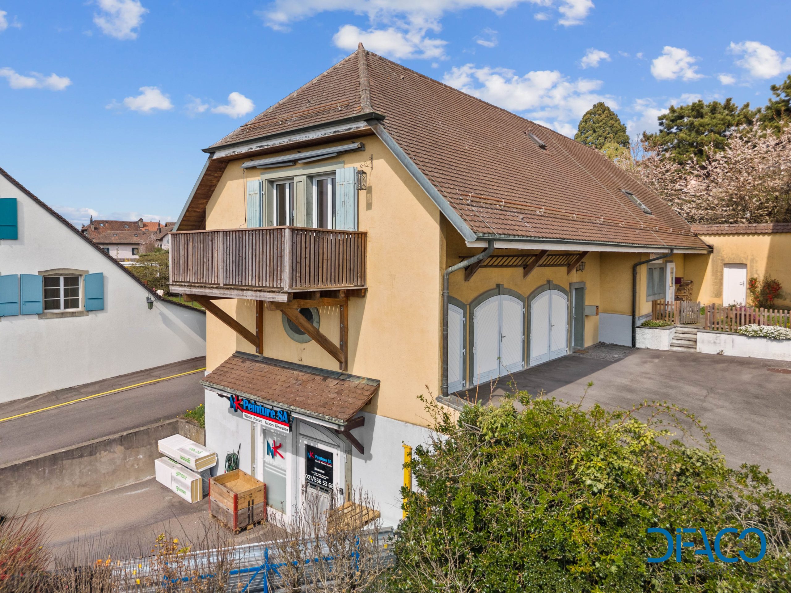 Außenansicht eines Landhauses mit steilem Walmdach und Balkon