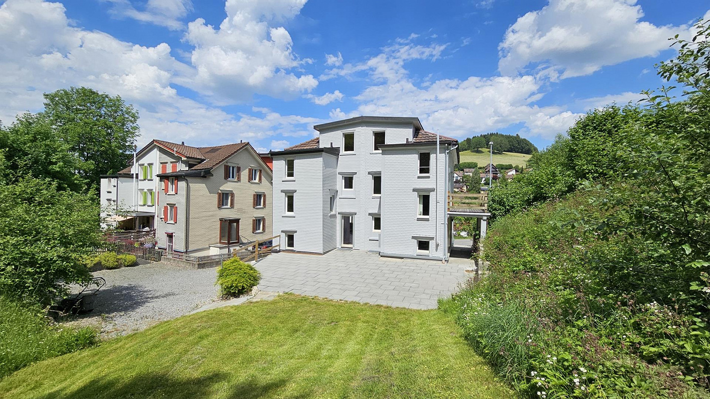 Mehrfamilienhaus mit Garten und Bergblick