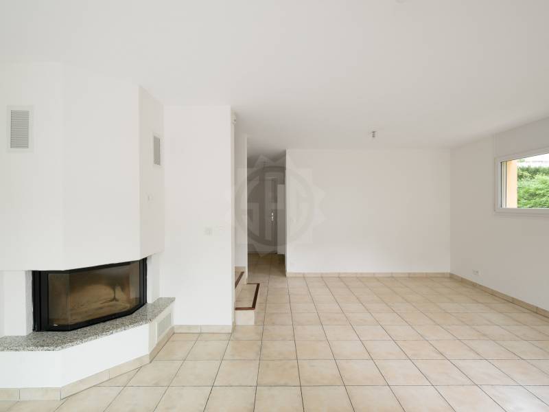 Wohnzimmer mit Kamin und Fliesenboden