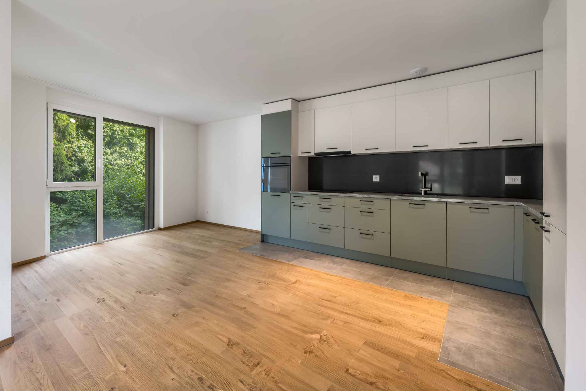 Moderne Wohnküche mit bodentiefem Fenster