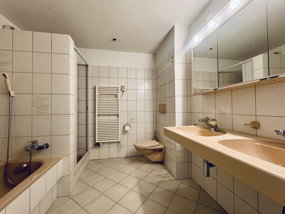 Badezimmer mit Doppelwaschtisch und Badewanne