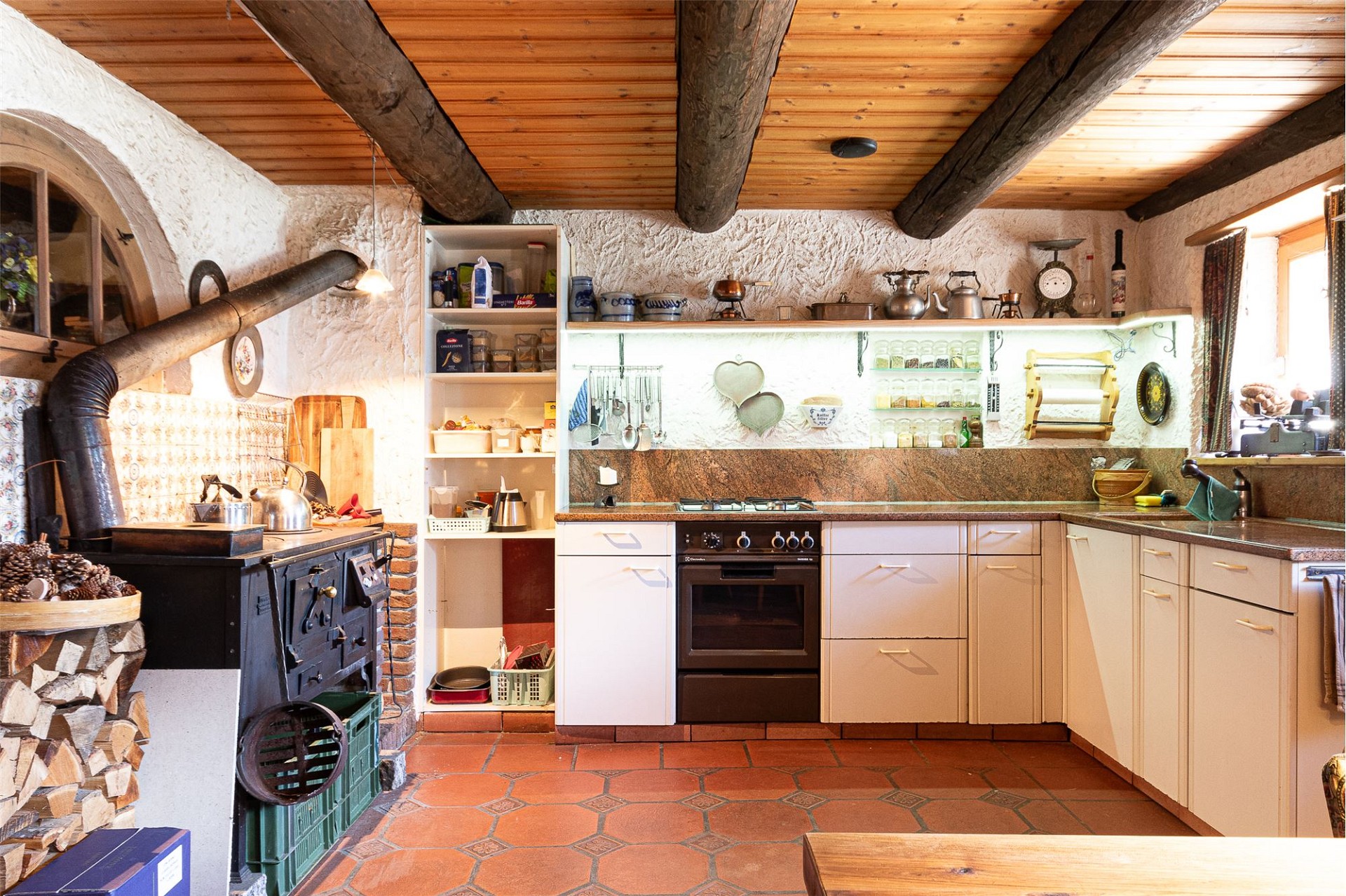 Rustikale Landhausküche mit Holzdecke und Holzofen