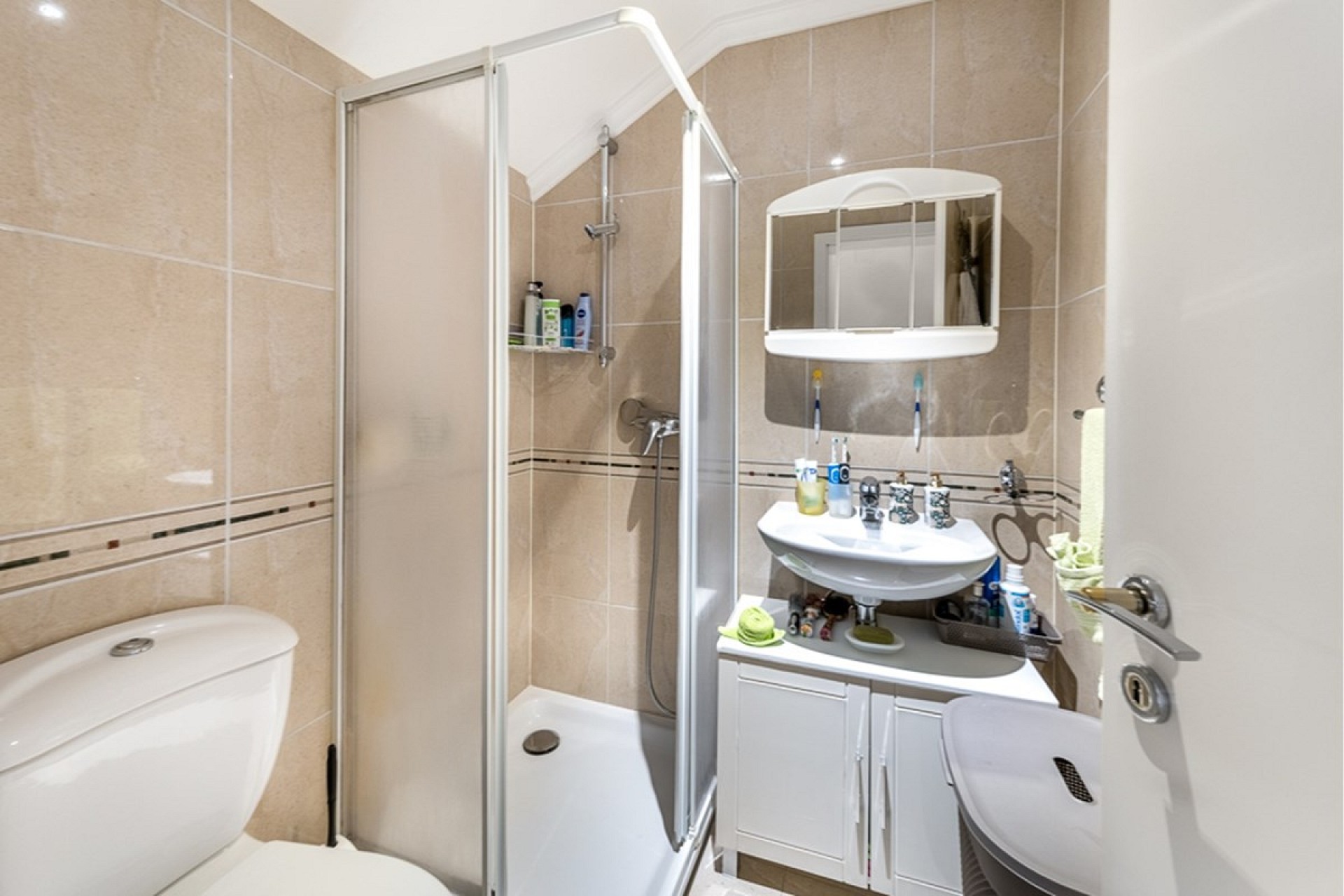 Kleines Badezimmer mit Dusche und Waschplatz