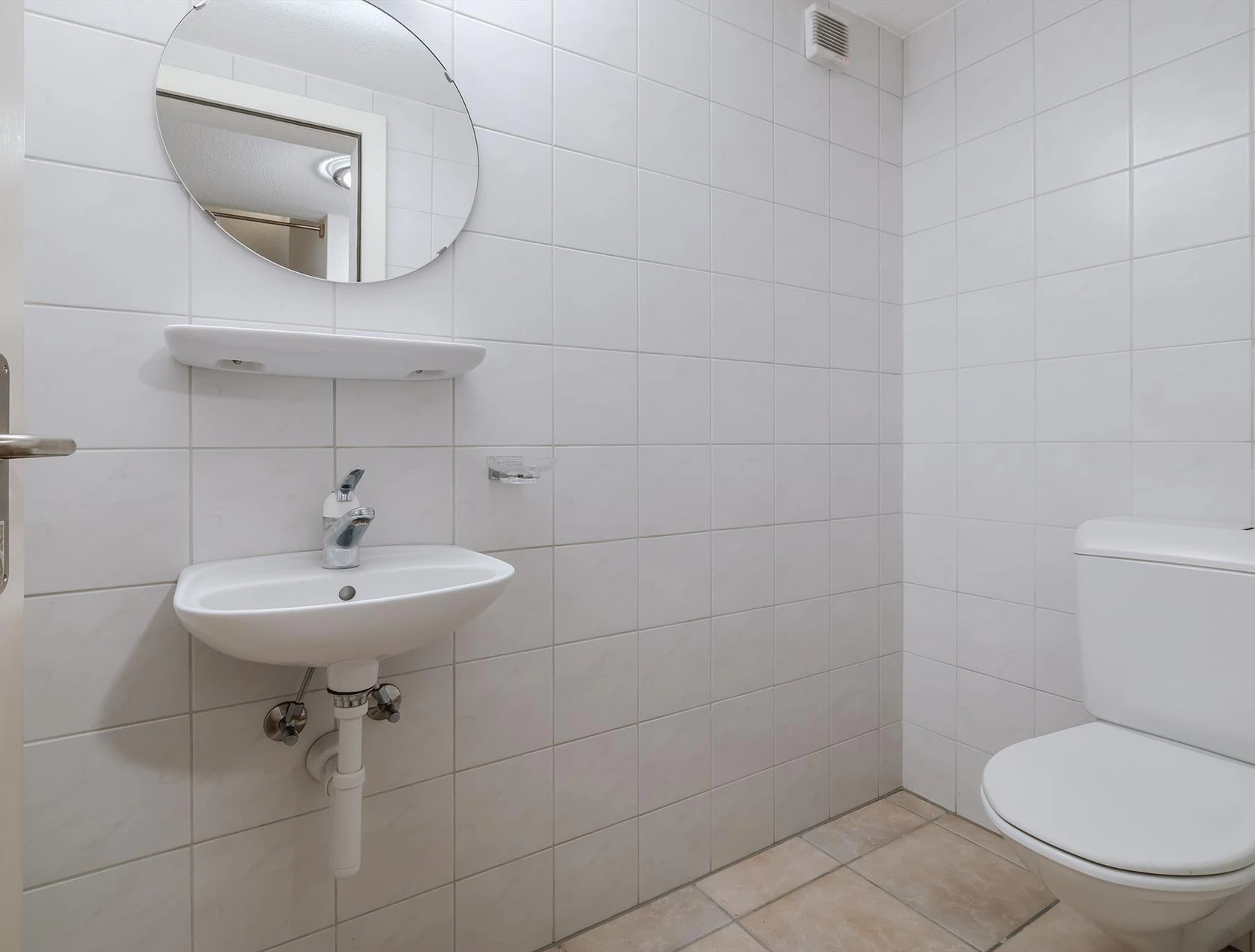Kleines Gäste-WC mit Wandfliesen und Waschbecken