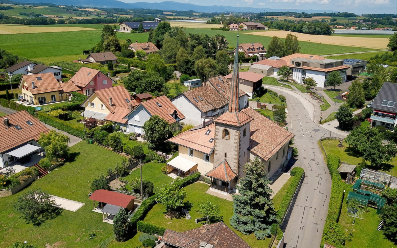 Luftaufnahme eines ländlichen Dorfes mit Kirche und Wohnhäusern
