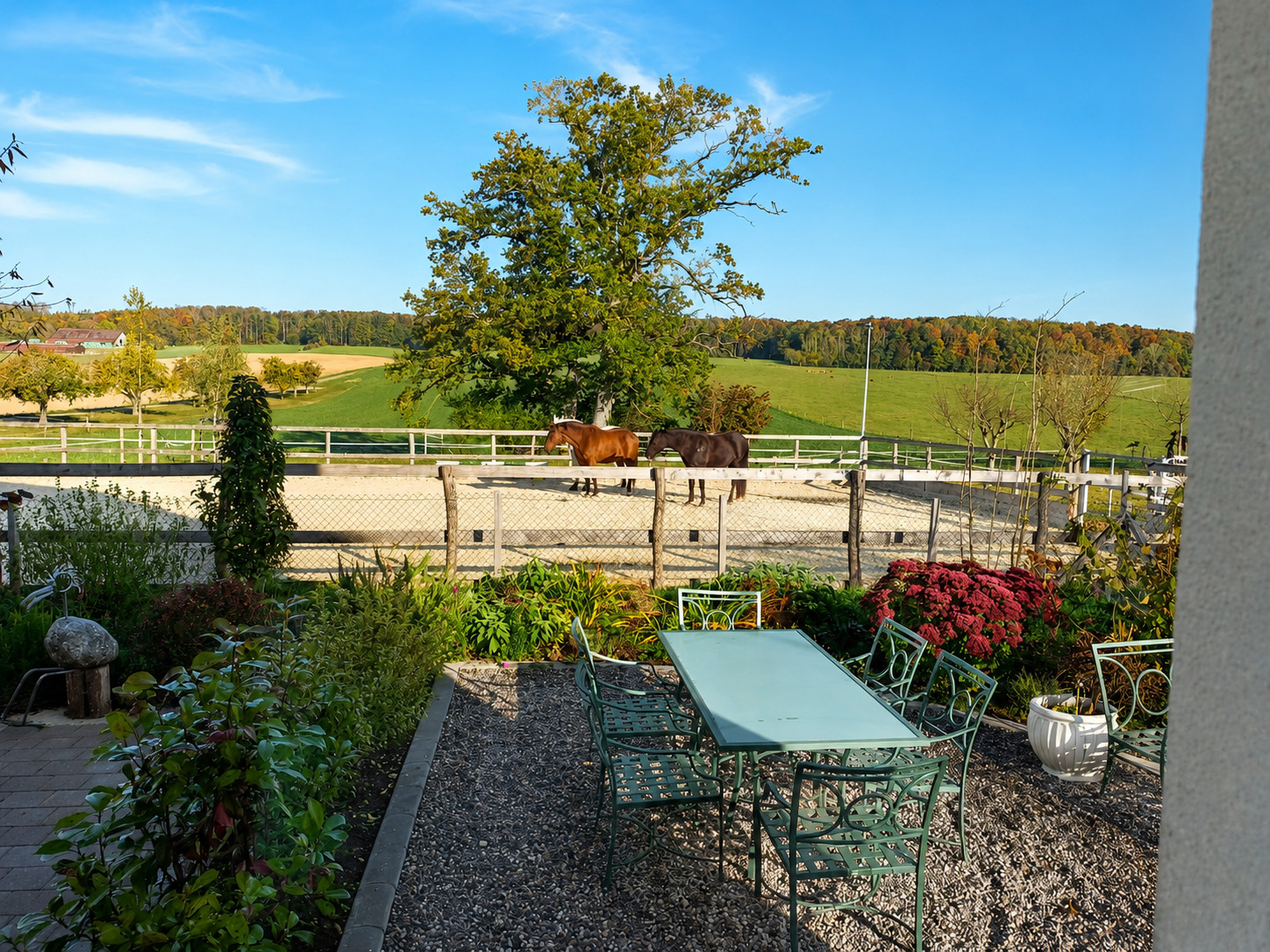 Terrasse mit Gartenmöbeln und Blick auf Pferdekoppel