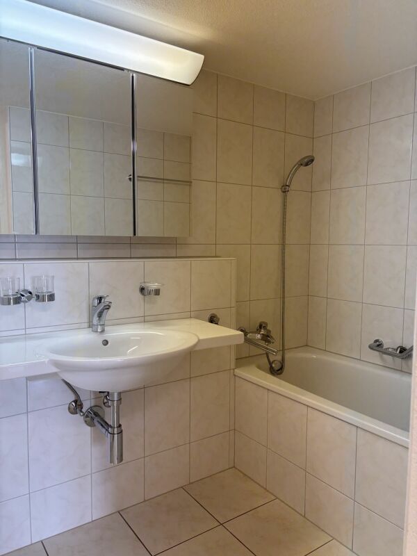 Helles Badezimmer mit Badewanne und Waschbecken