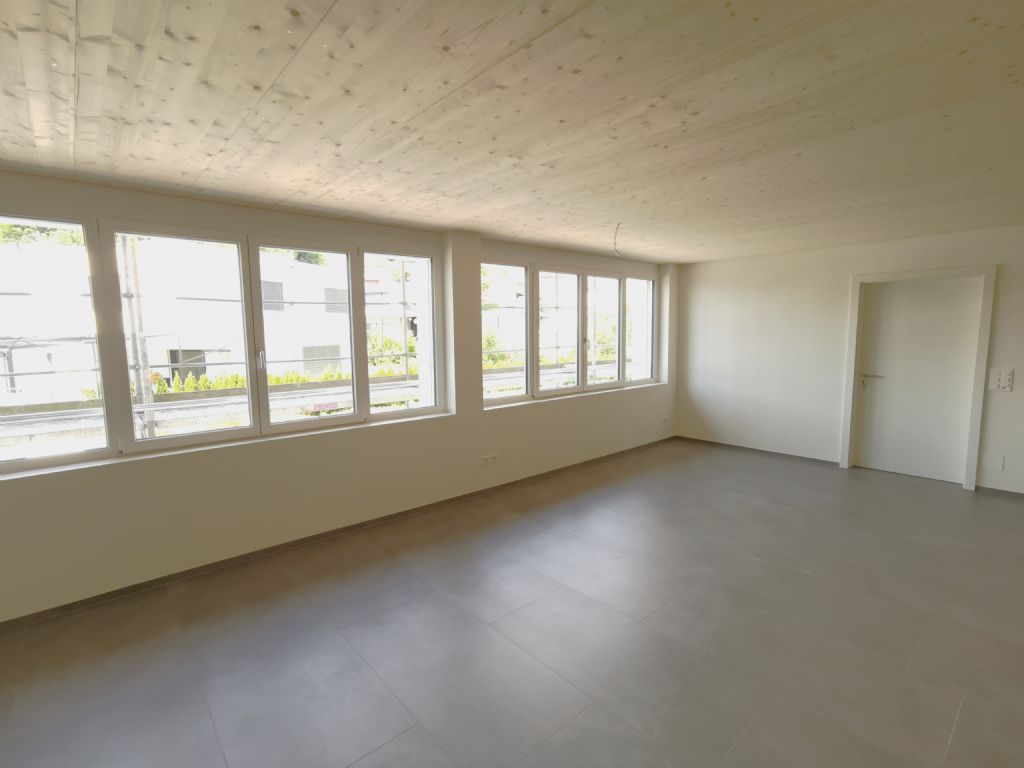Leerer heller Wohnraum mit großen Fenstern