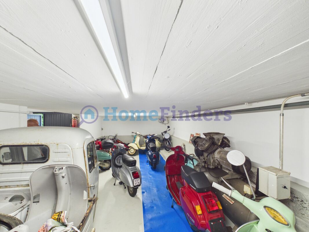 Garage mit Rollern und Oldtimer-Fahrzeug