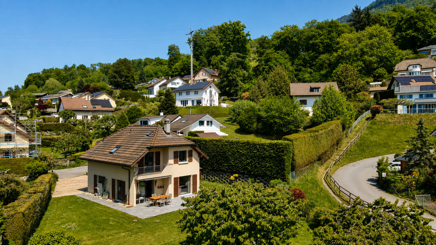 Luftaufnahme eines Wohnhauses in grüner Hanglage