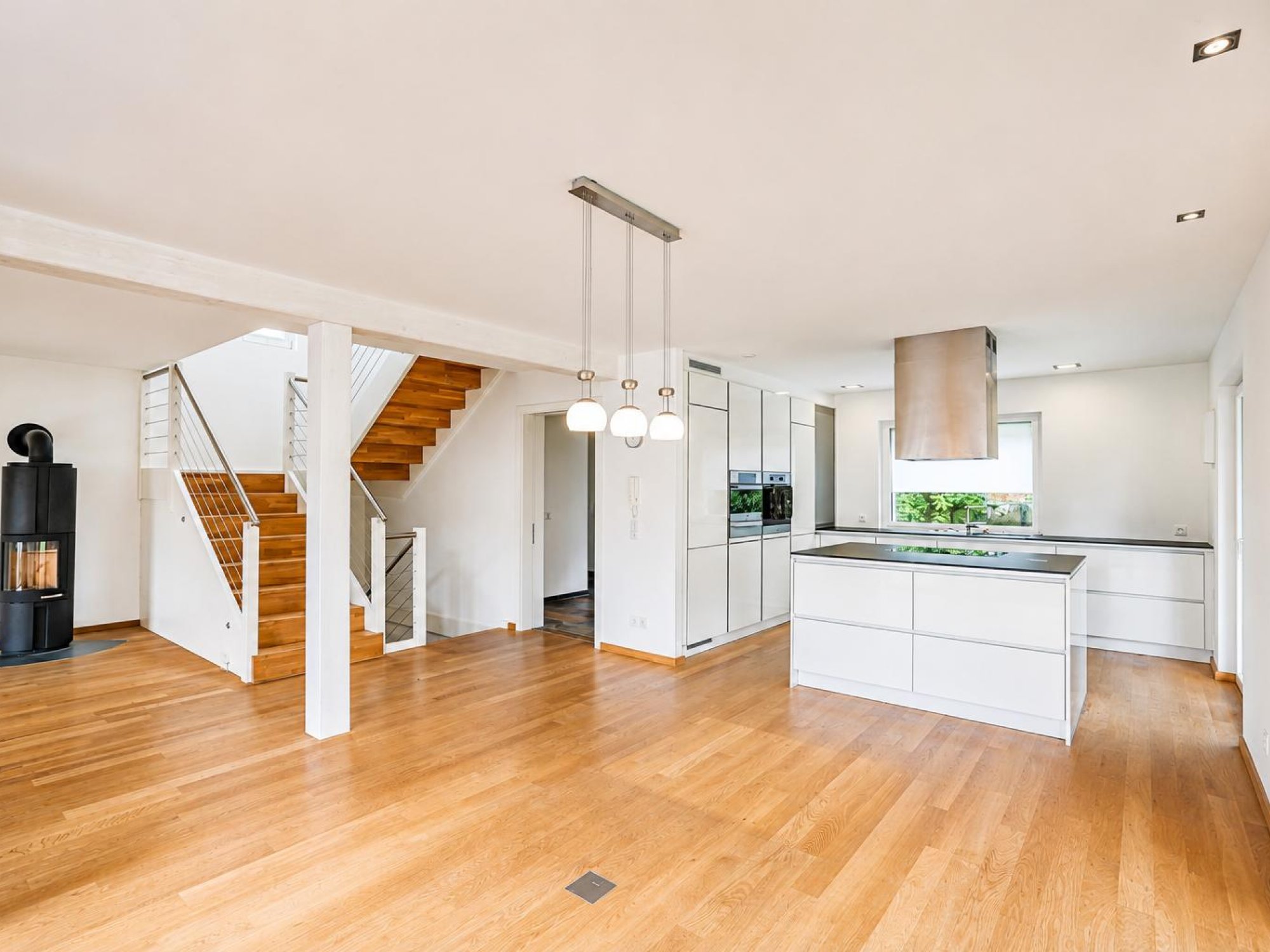 Offener Wohnbereich mit moderner Küche und Treppe