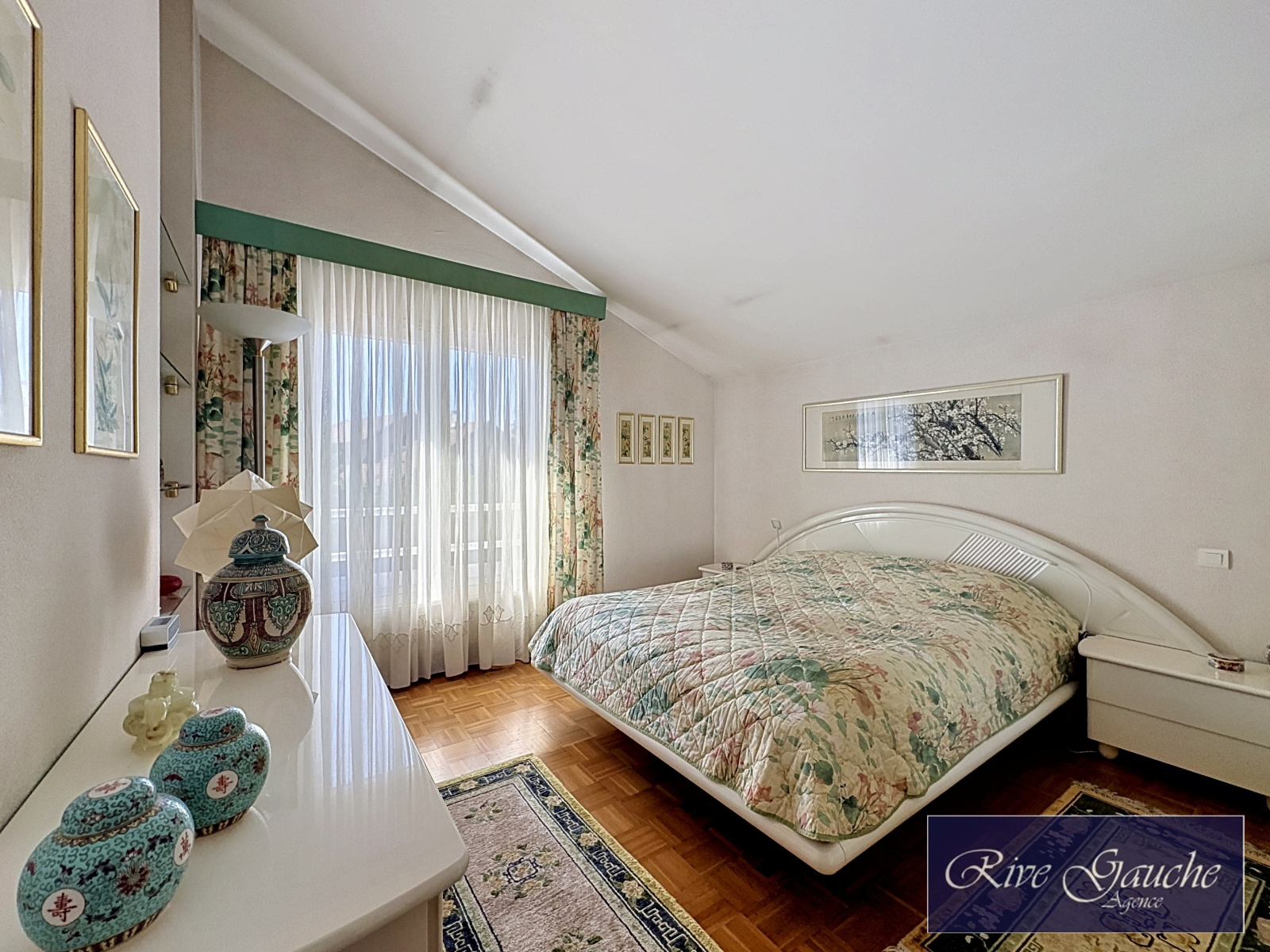 Schlafzimmer mit Dachschräge und floraler Einrichtung