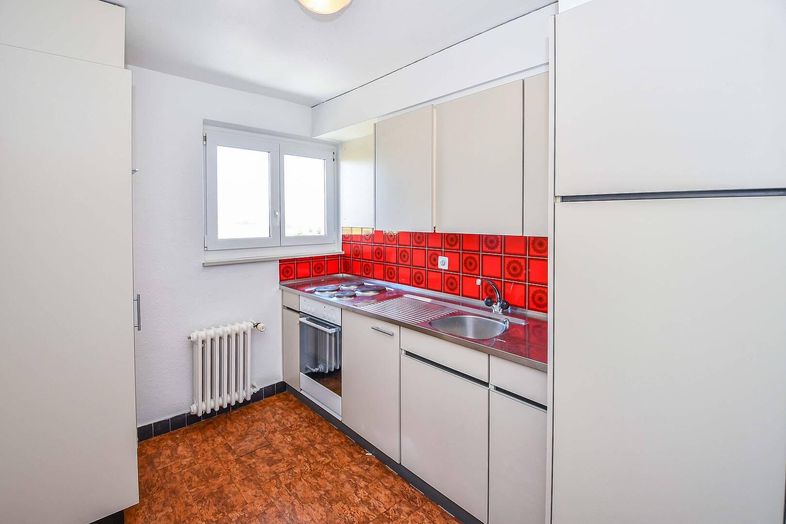 Kleine helle Küche mit Retro-Fliesenspiegel