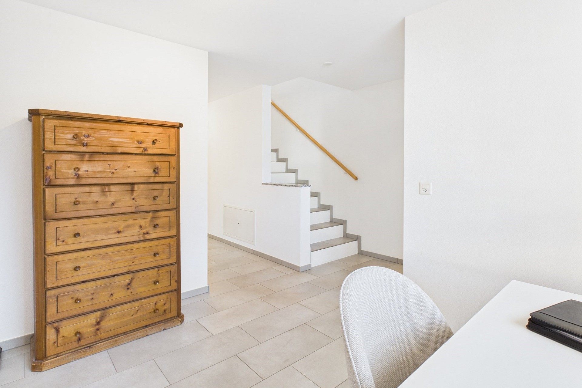 Heller Flur mit Treppe und Kommode