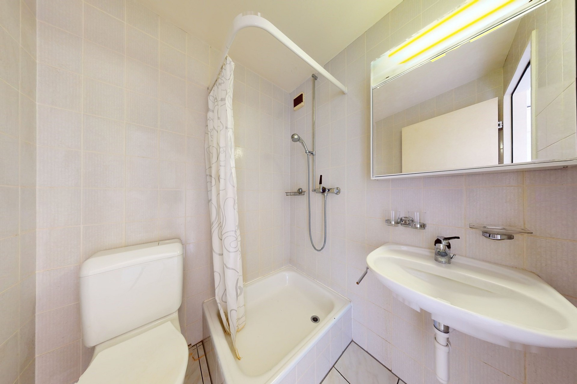 Kompaktes Badezimmer mit Badewanne, WC und Waschbecken