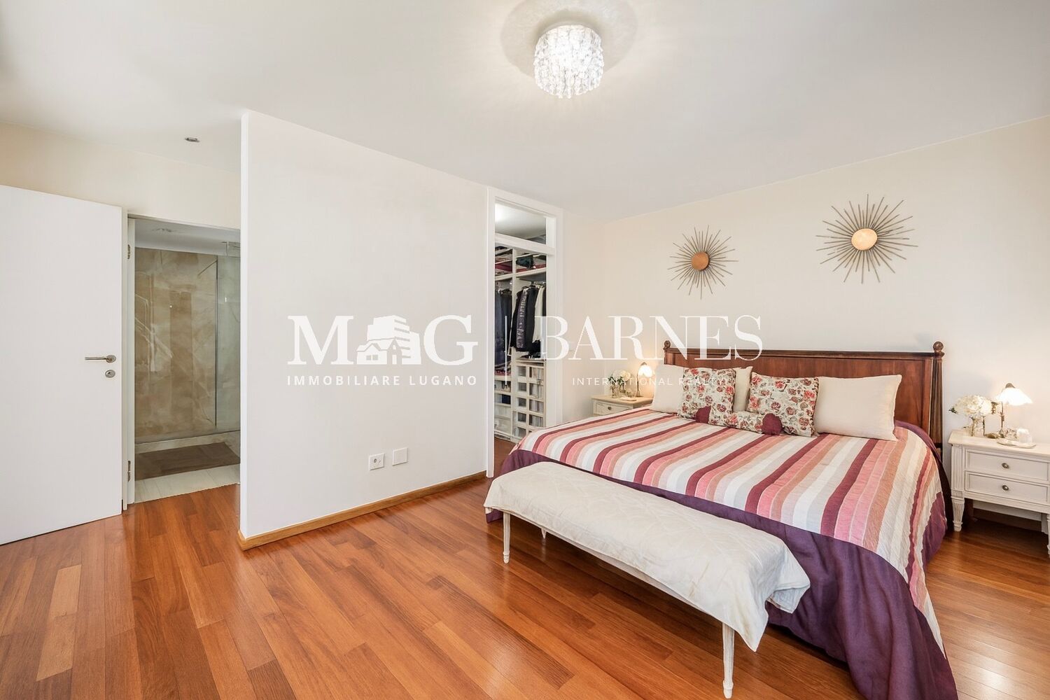 Schlafzimmer mit Holzfußboden und offenem Badzugang
