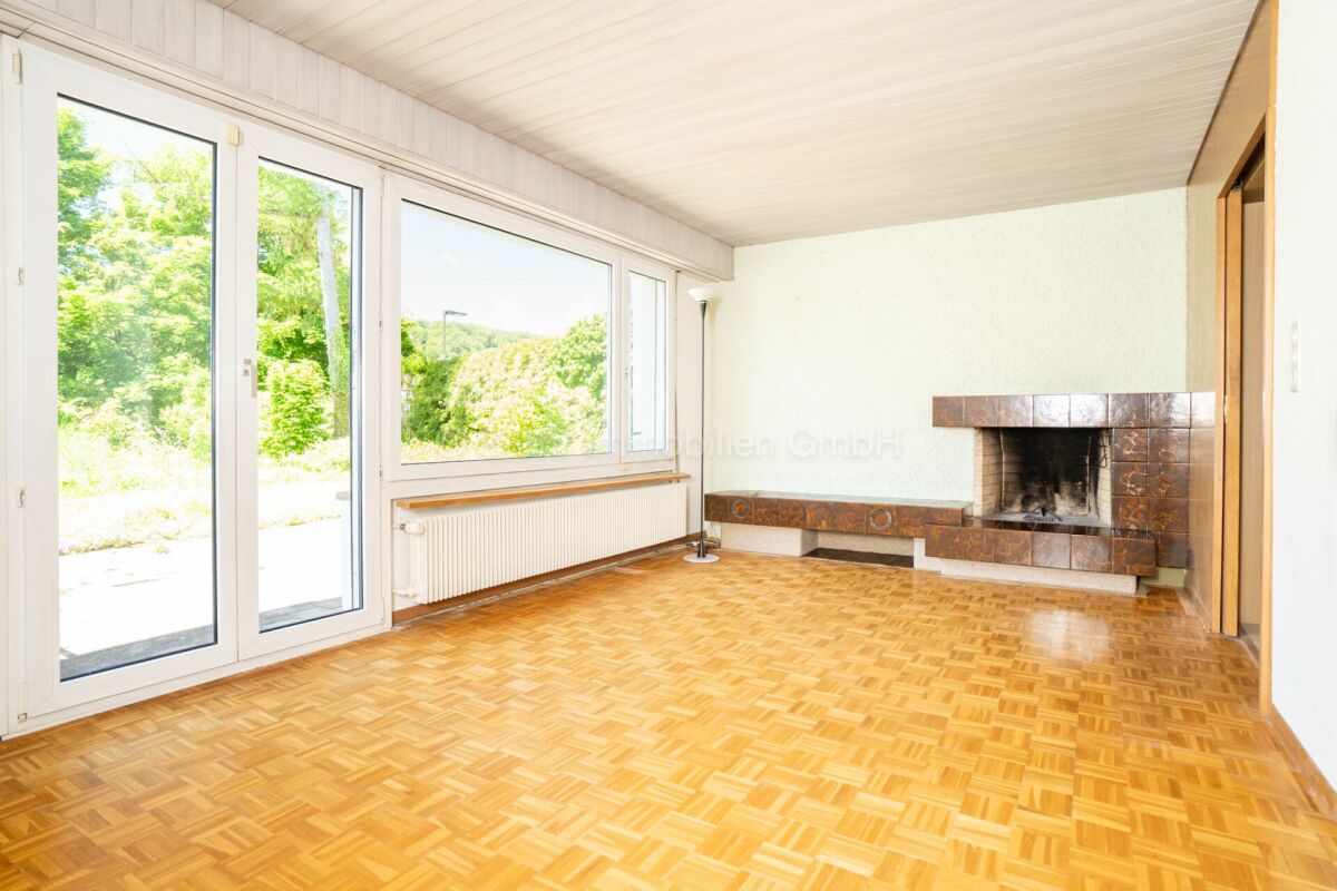 Wohnraum mit Kamin und großer Fensterfront