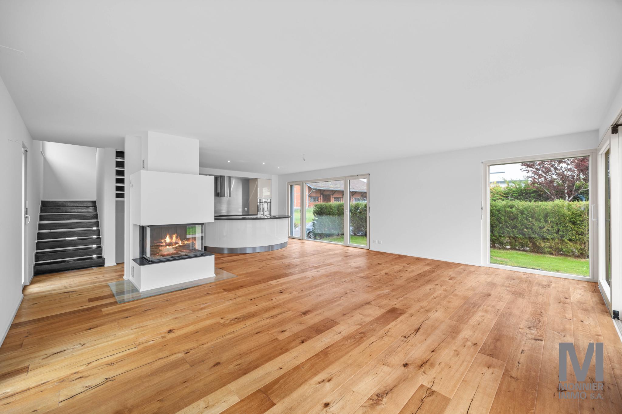 Offener Wohnbereich mit Kamin und Gartenblick