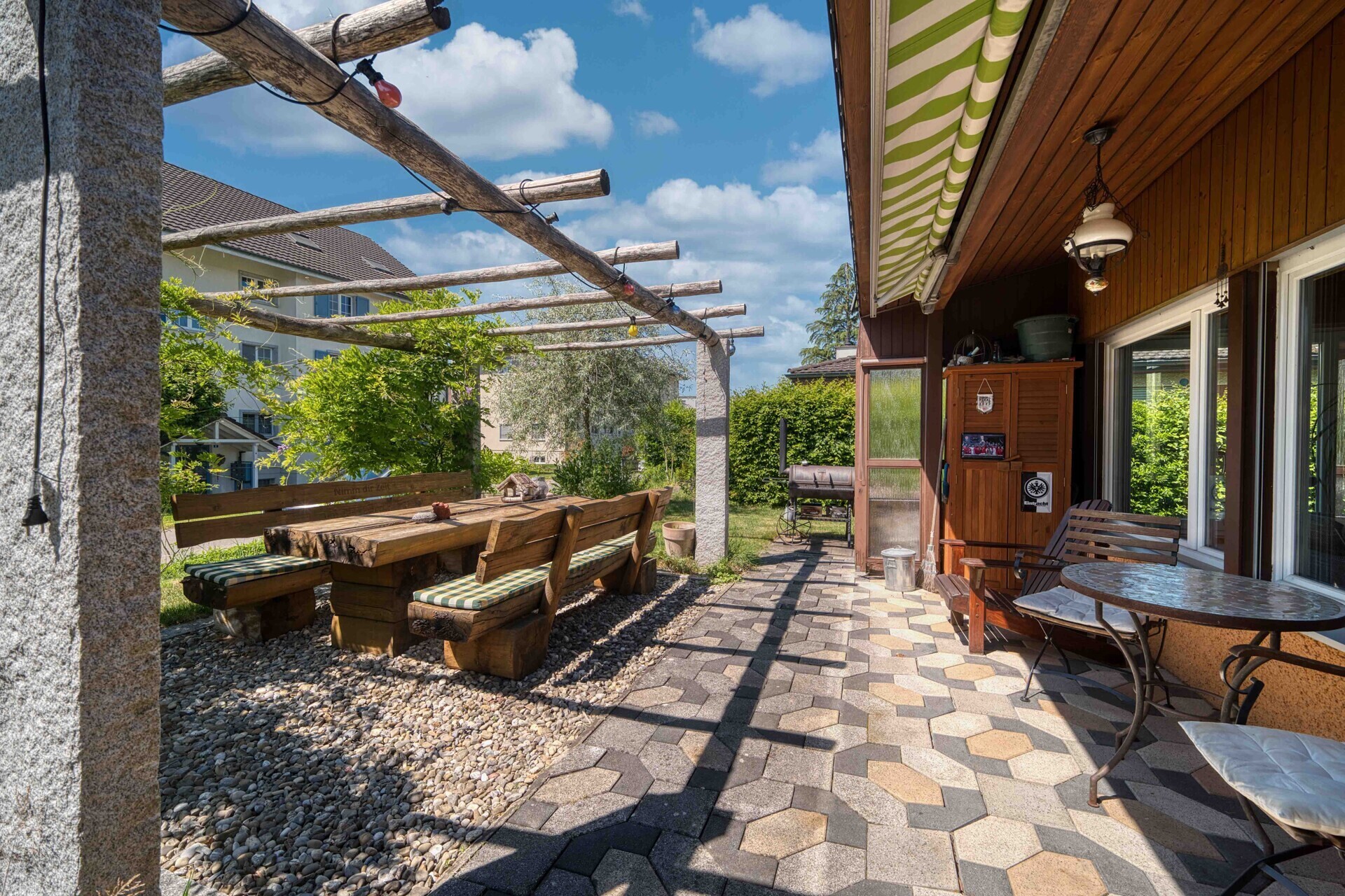 Überdachte Terrasse mit Garten und Grillbereich