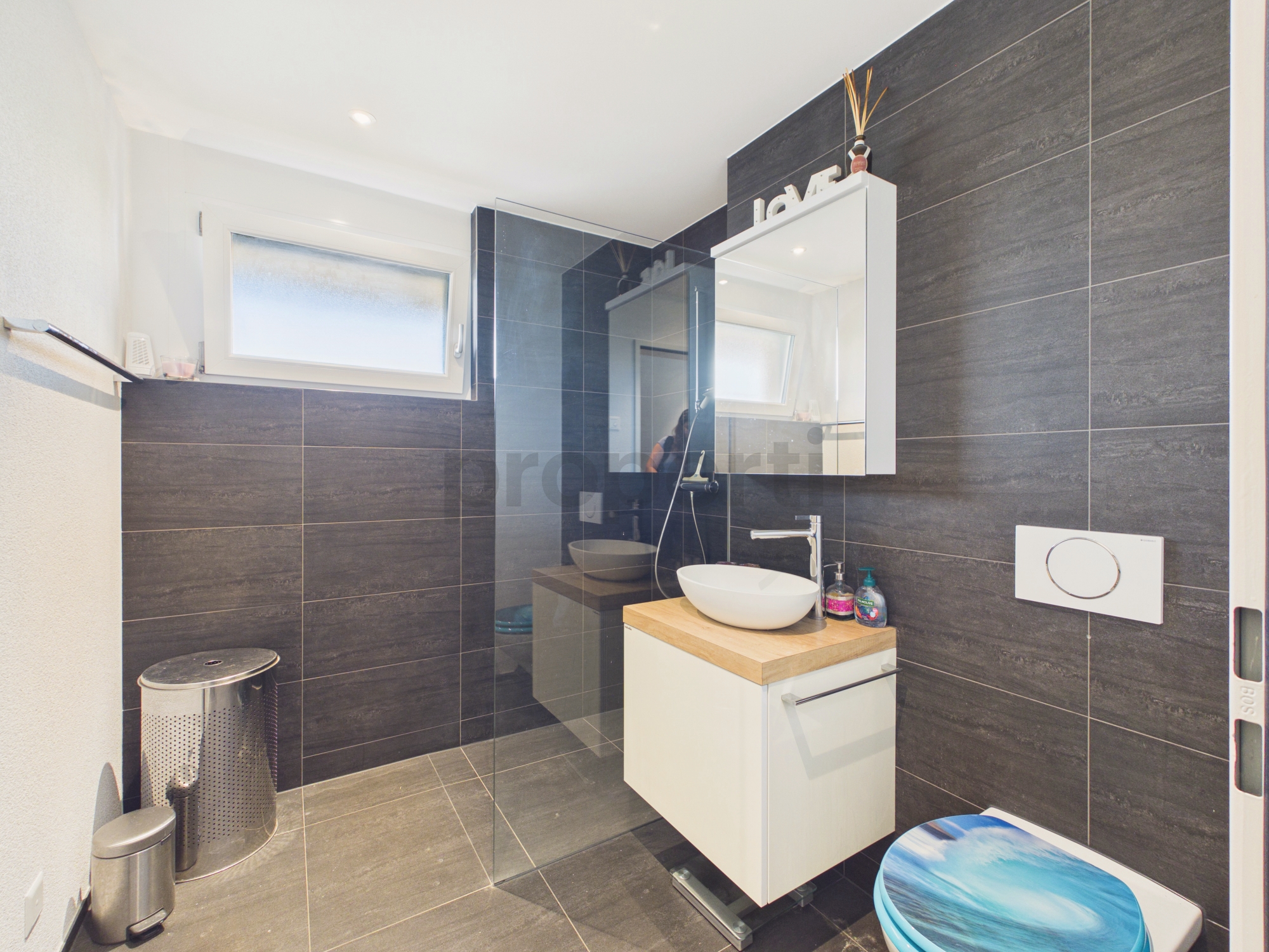 Modernes Badezimmer mit dunkler Wandverkleidung