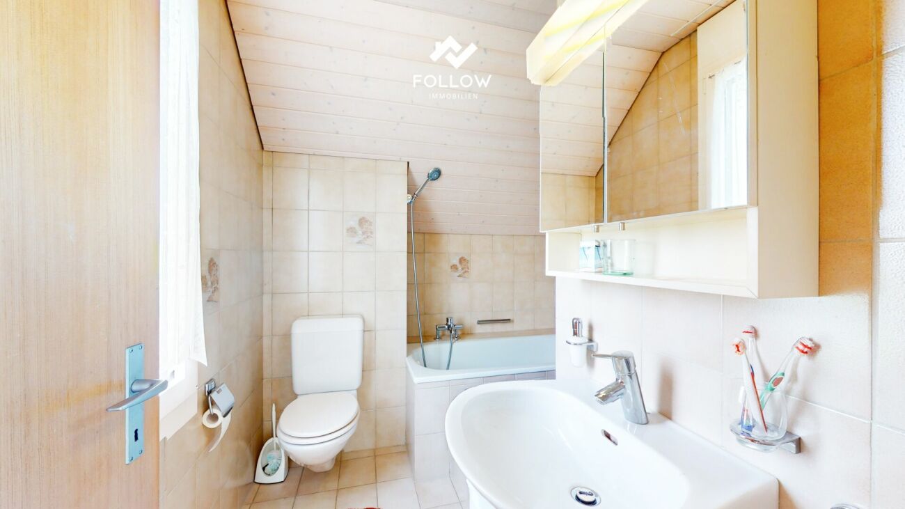 Badezimmer mit Badewanne und Waschtisch