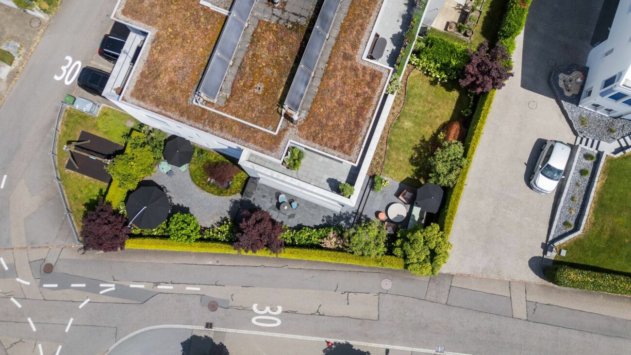 Luftaufnahme eines Wohnhauses mit Garten und Einfahrt