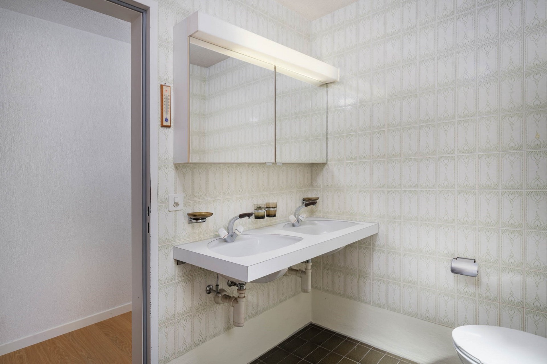 Kleines Badezimmer mit Doppelwaschtisch und Spiegelschrank