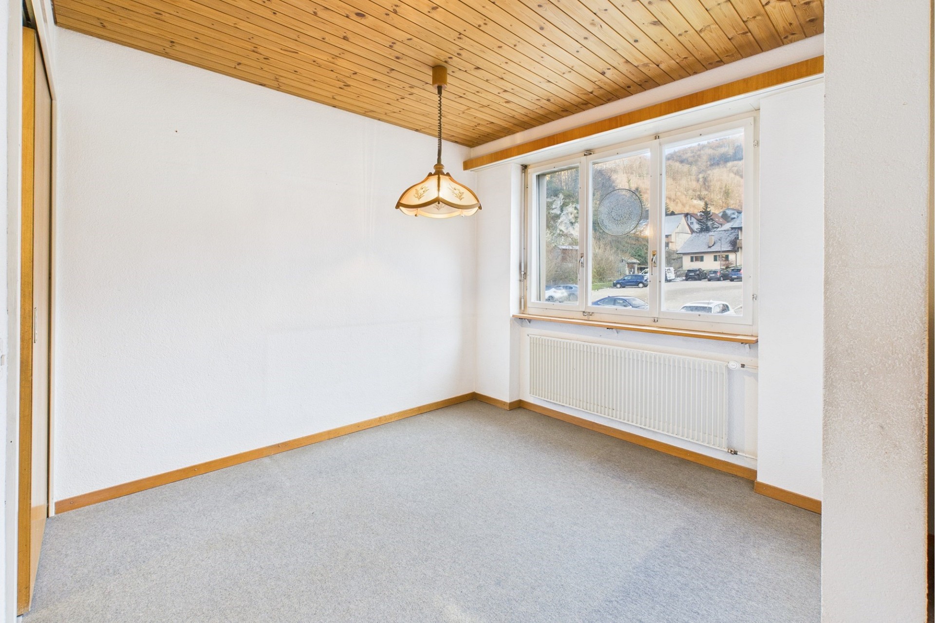Leeres Zimmer mit Holzdecke und Fenster