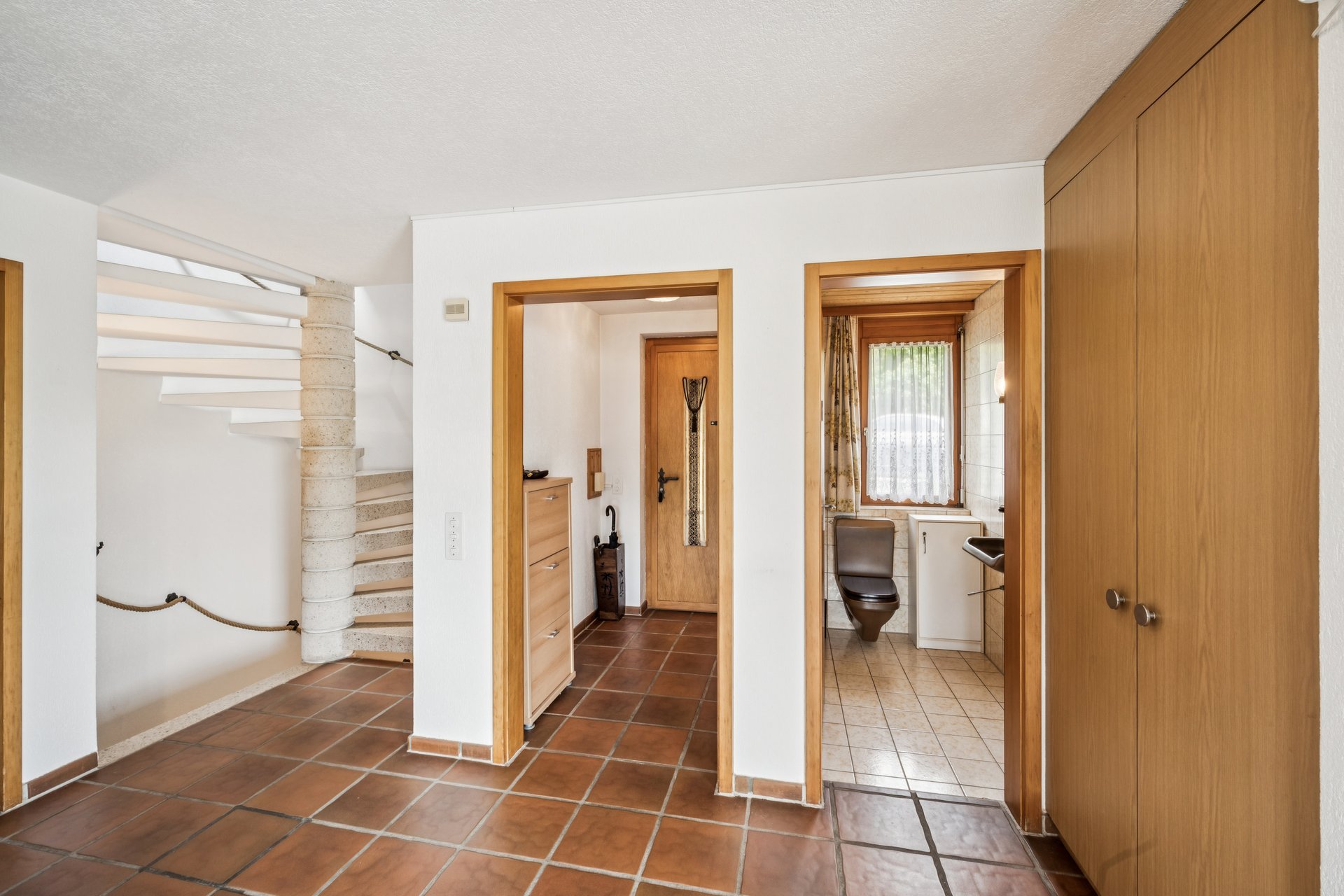 Heller Eingangsbereich mit Treppe und WC