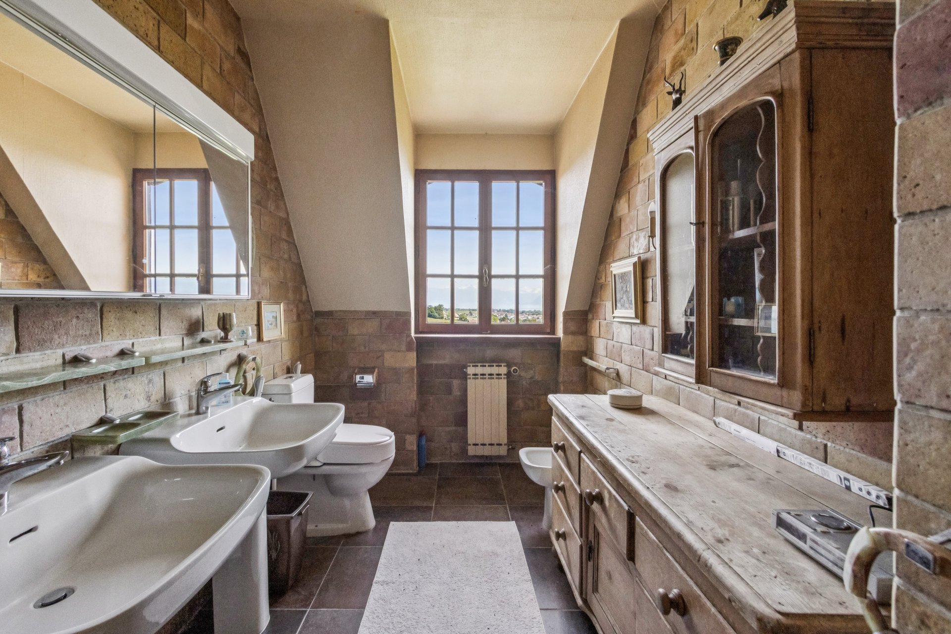 Rustikales Badezimmer mit Fenster und Landhausmöbeln