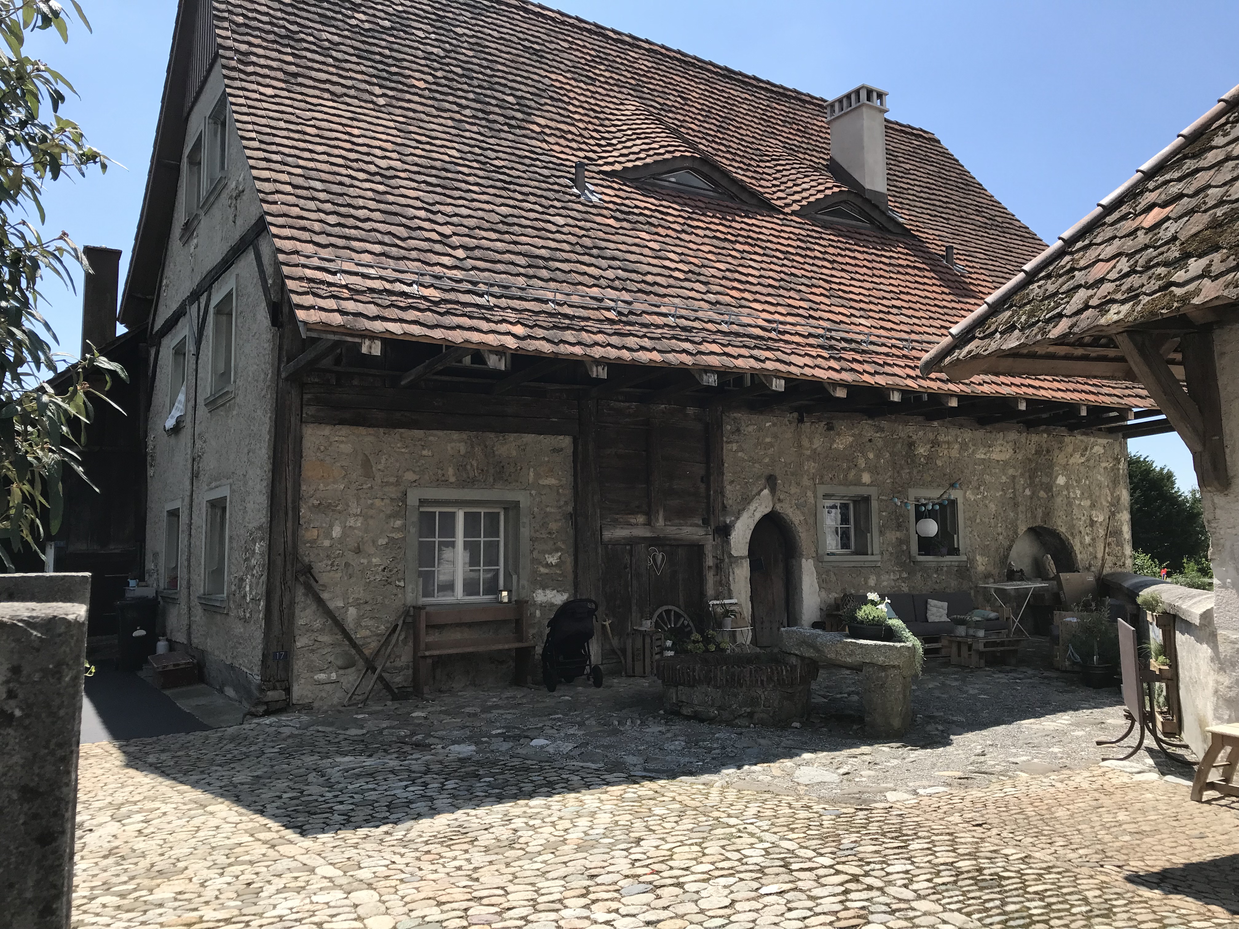 Historisches Steinhaus mit großem Ziegeldach und Innenhof