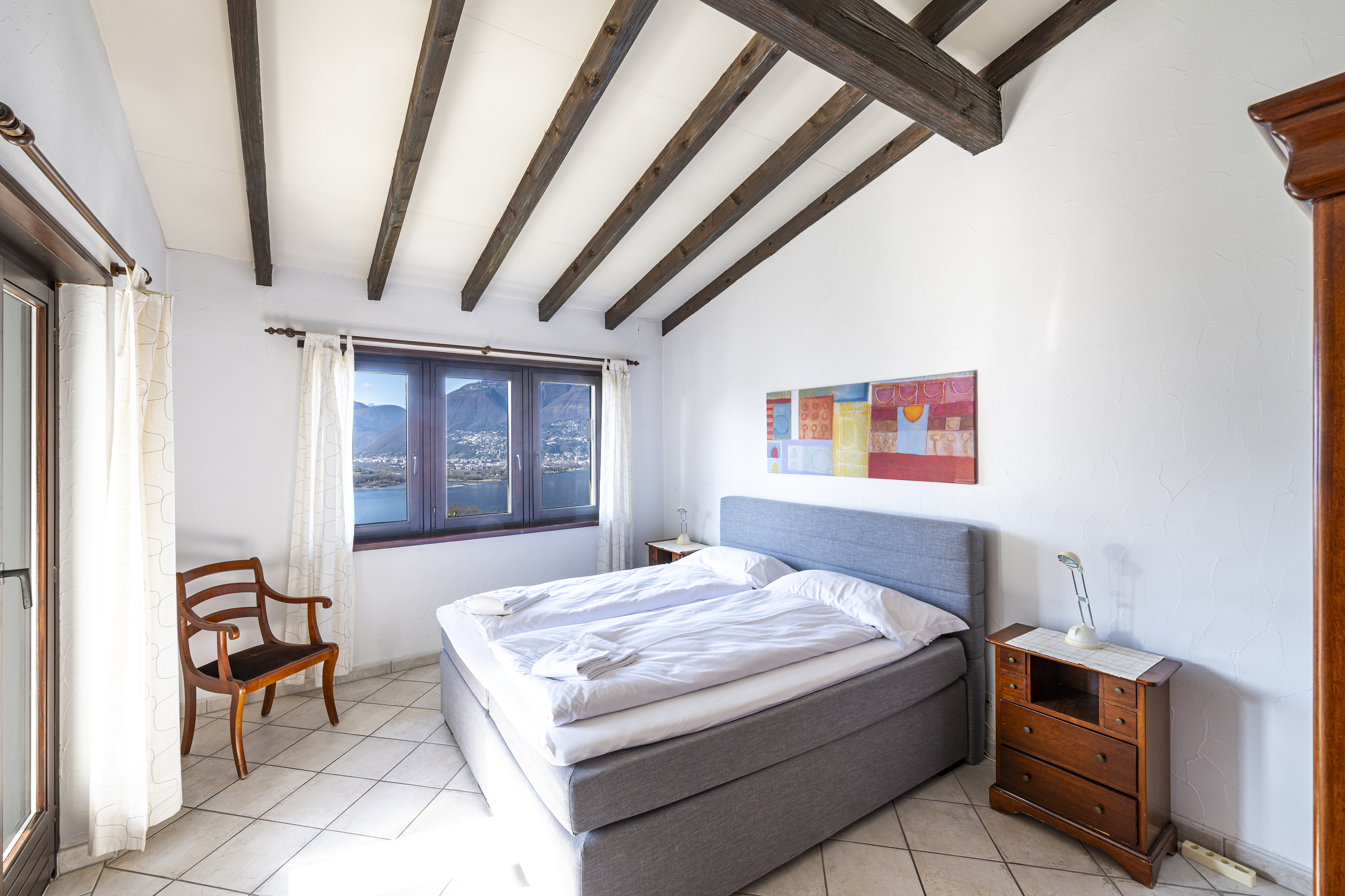 Helles Schlafzimmer mit Berg- und Seeblick