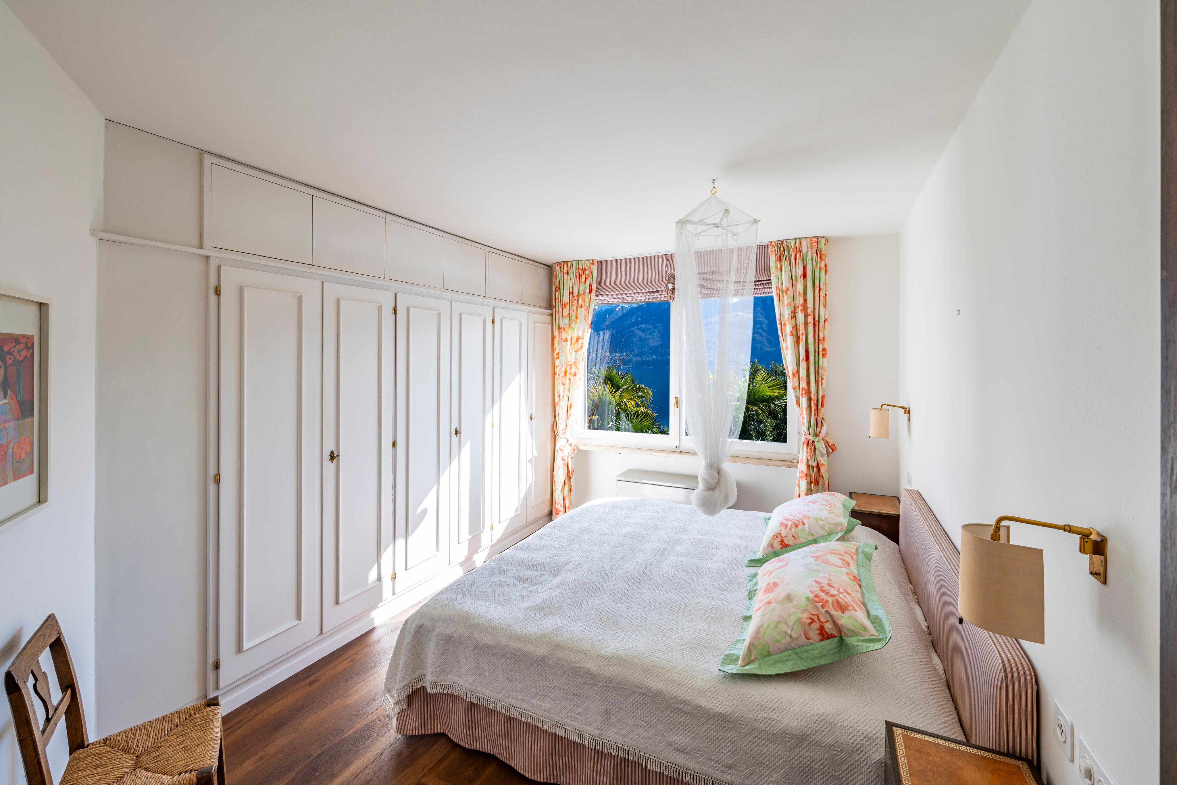 Helles Schlafzimmer mit Einbauschränken und Bergblick