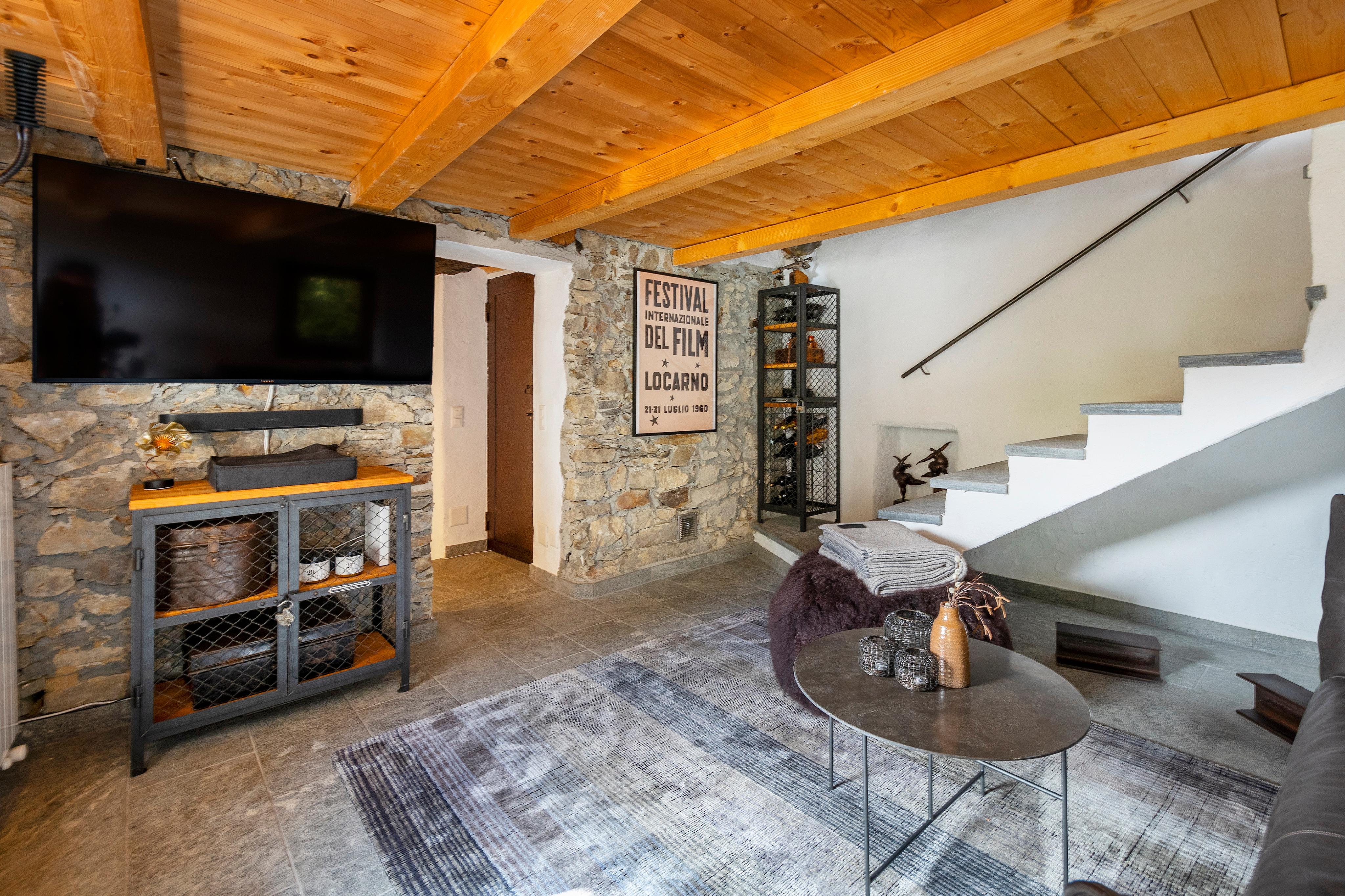Gemütliches Wohnzimmer mit Steindetails und Holzdecke