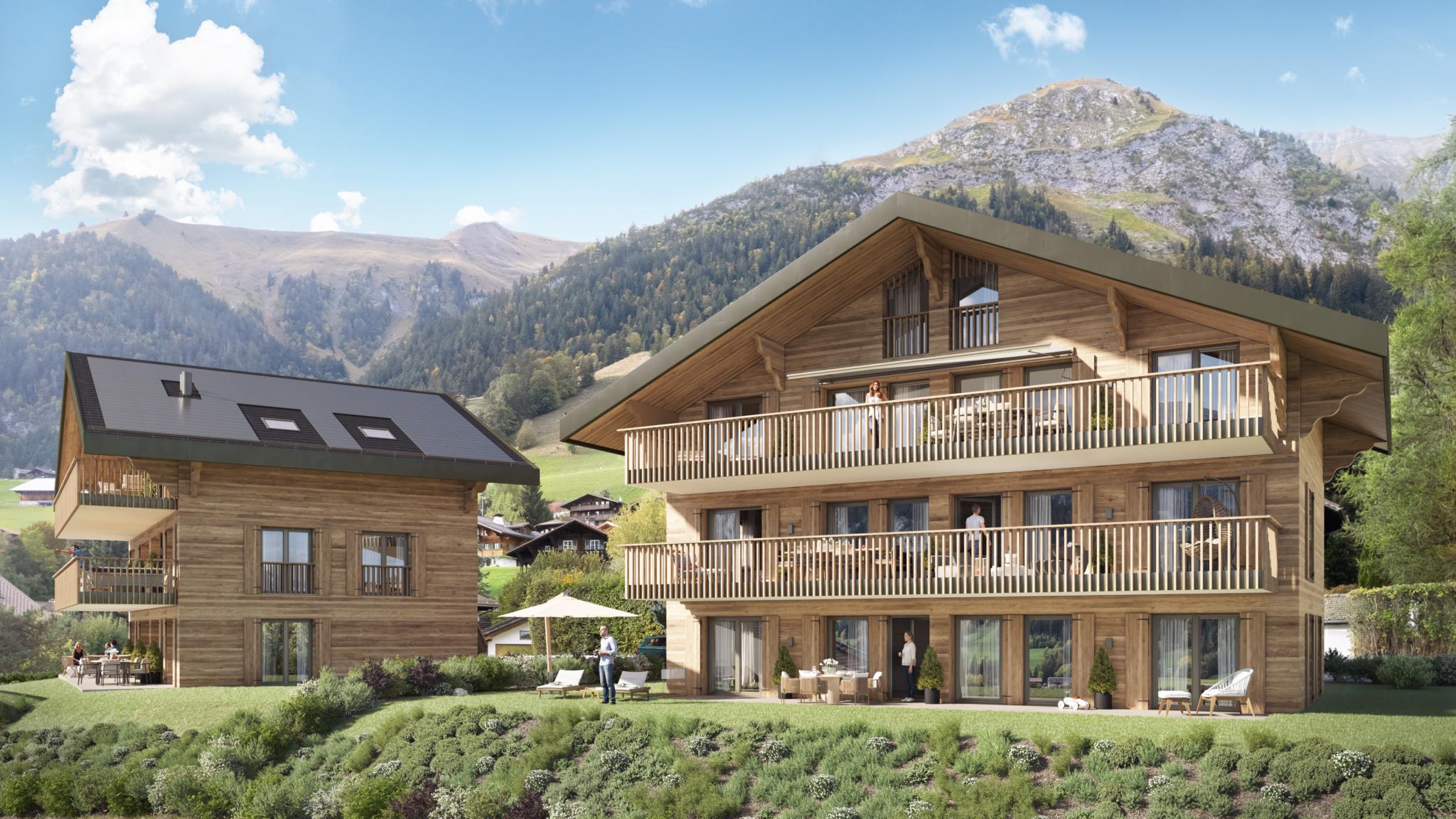 Alpine-Chalets mit Balkonen vor Bergkulisse