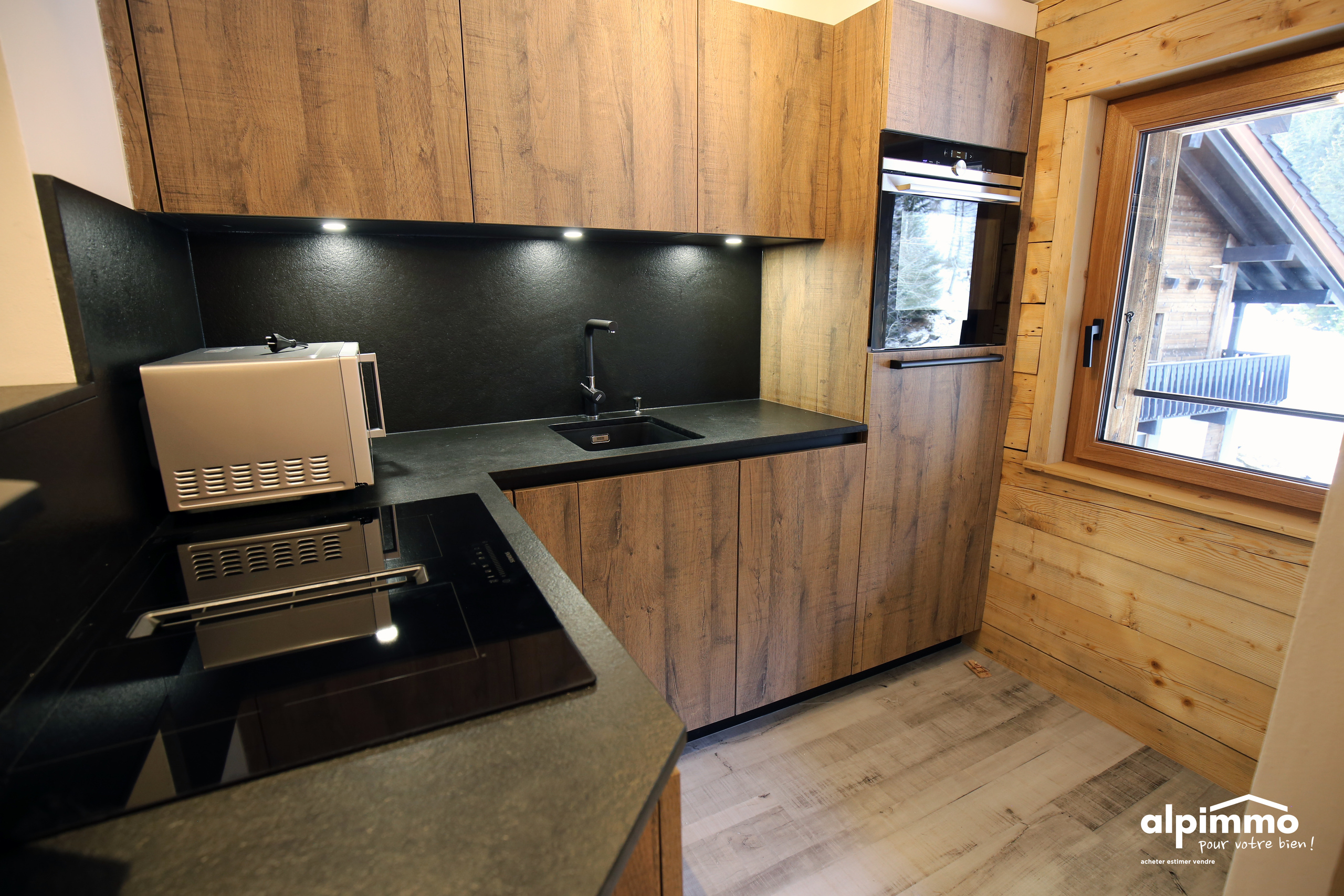 Moderne Holzküche mit schwarzer Arbeitsfläche
