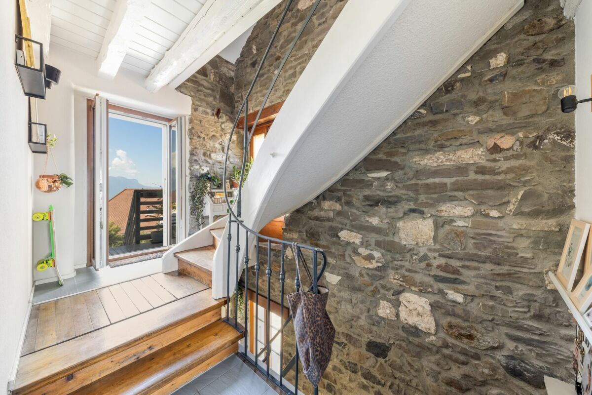 Treppe mit Natursteinwand und Bergblick
