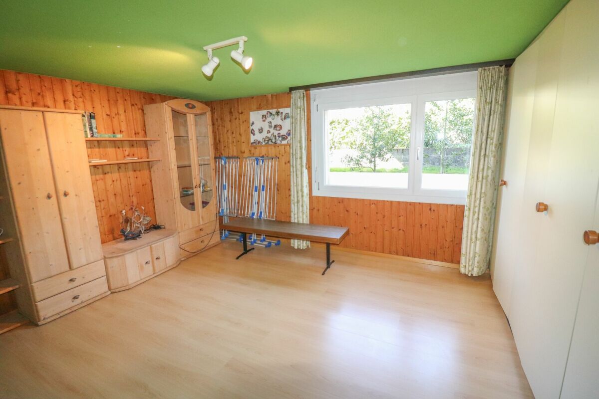 Heller Raum mit Holzverkleidung und grün gestrichener Decke