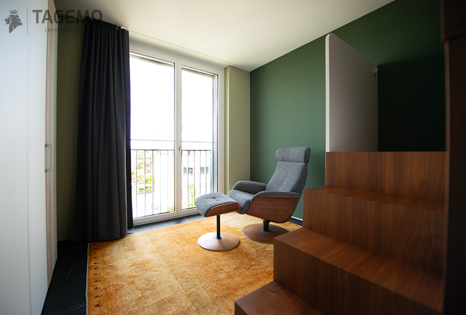 Modernes Schlafzimmer mit Balkon und Sessel