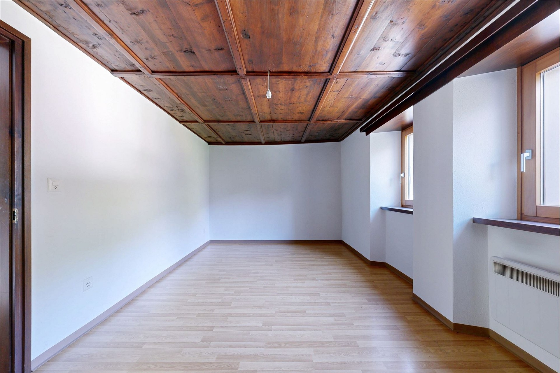 Leerer Dachgeschossraum mit Holzbalkendecke