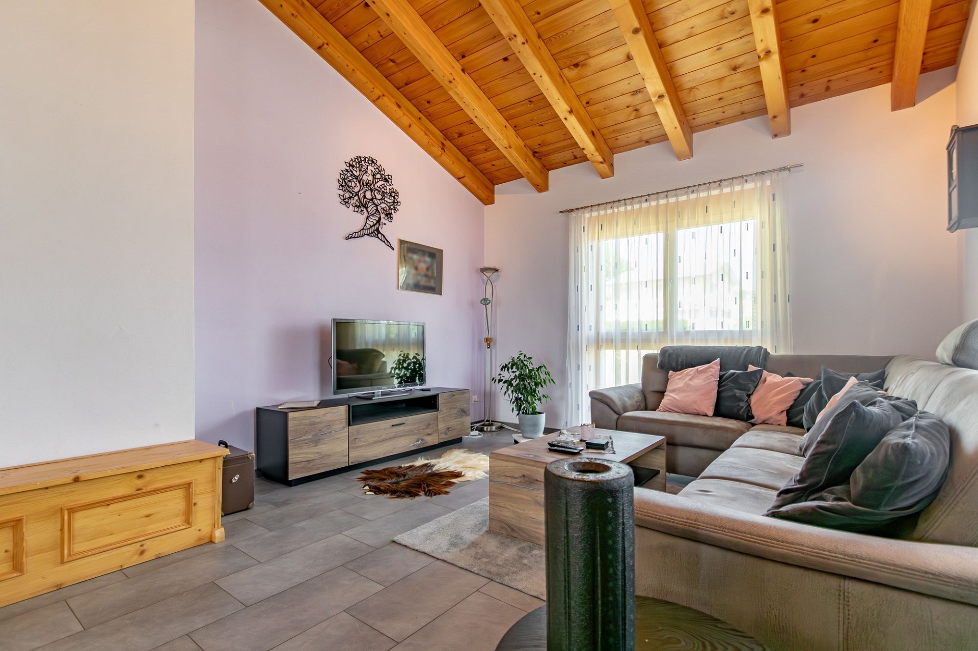 Heller Wohnraum mit Holzdecke und Ecksofa