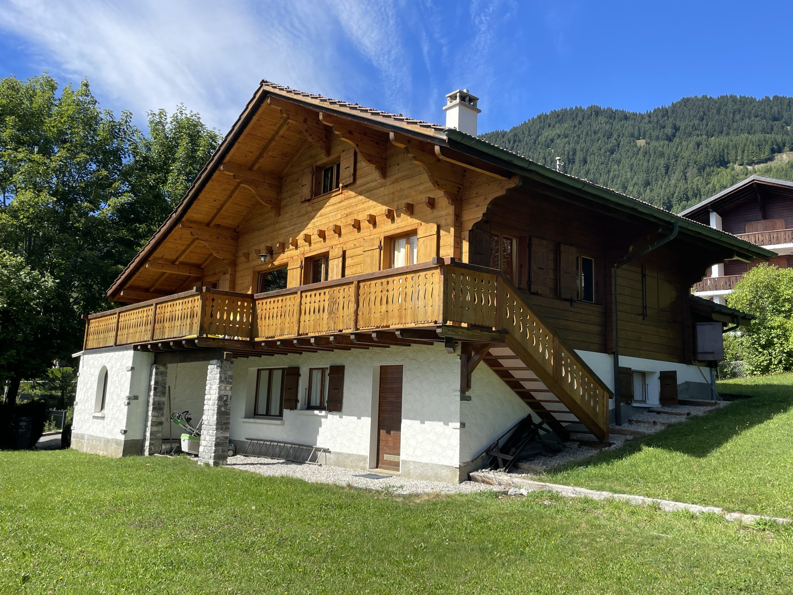 Alpines Holzhaus mit Balkon und Bergkulisse