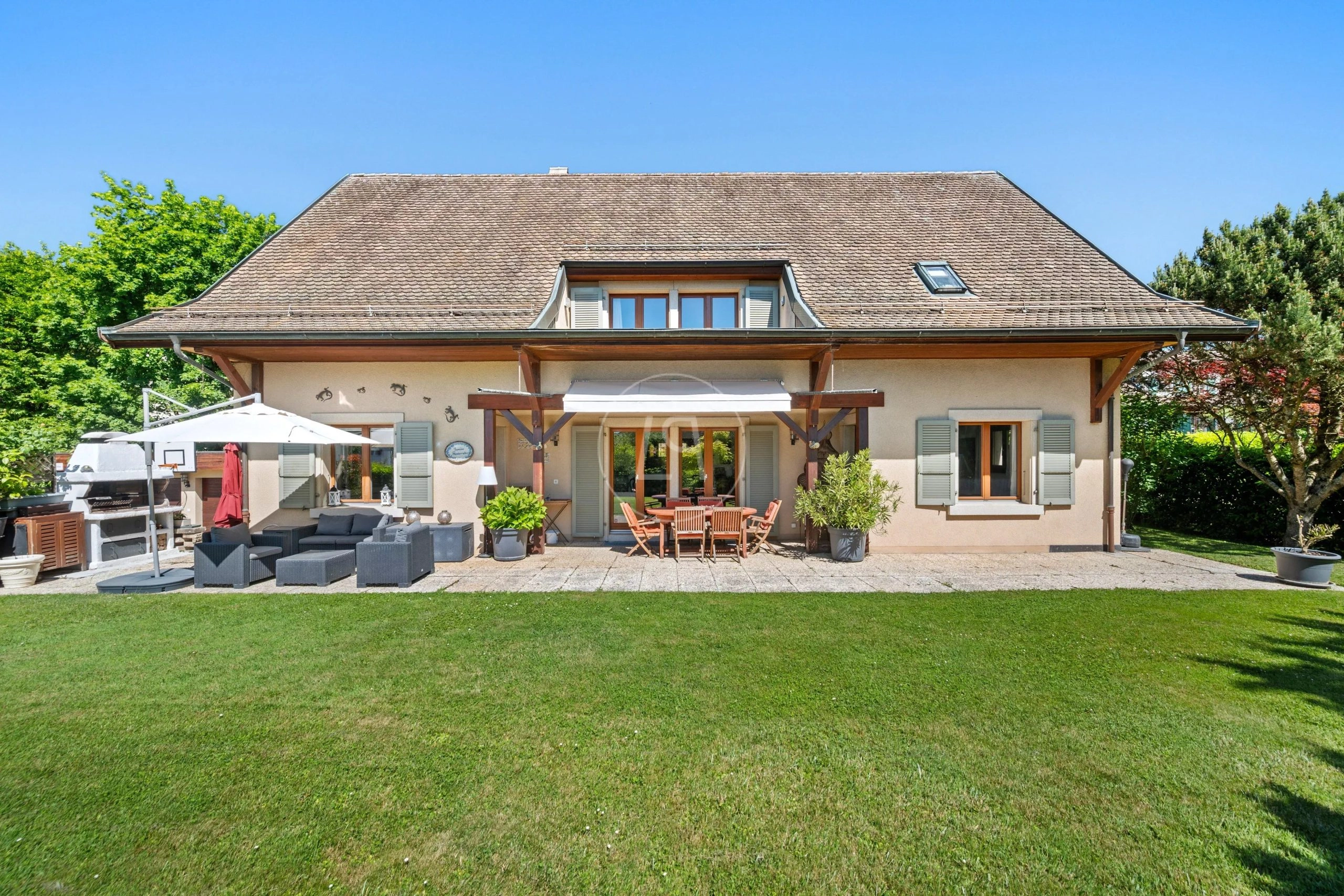 Großzügige Gartenseite eines Einfamilienhauses mit Terrasse