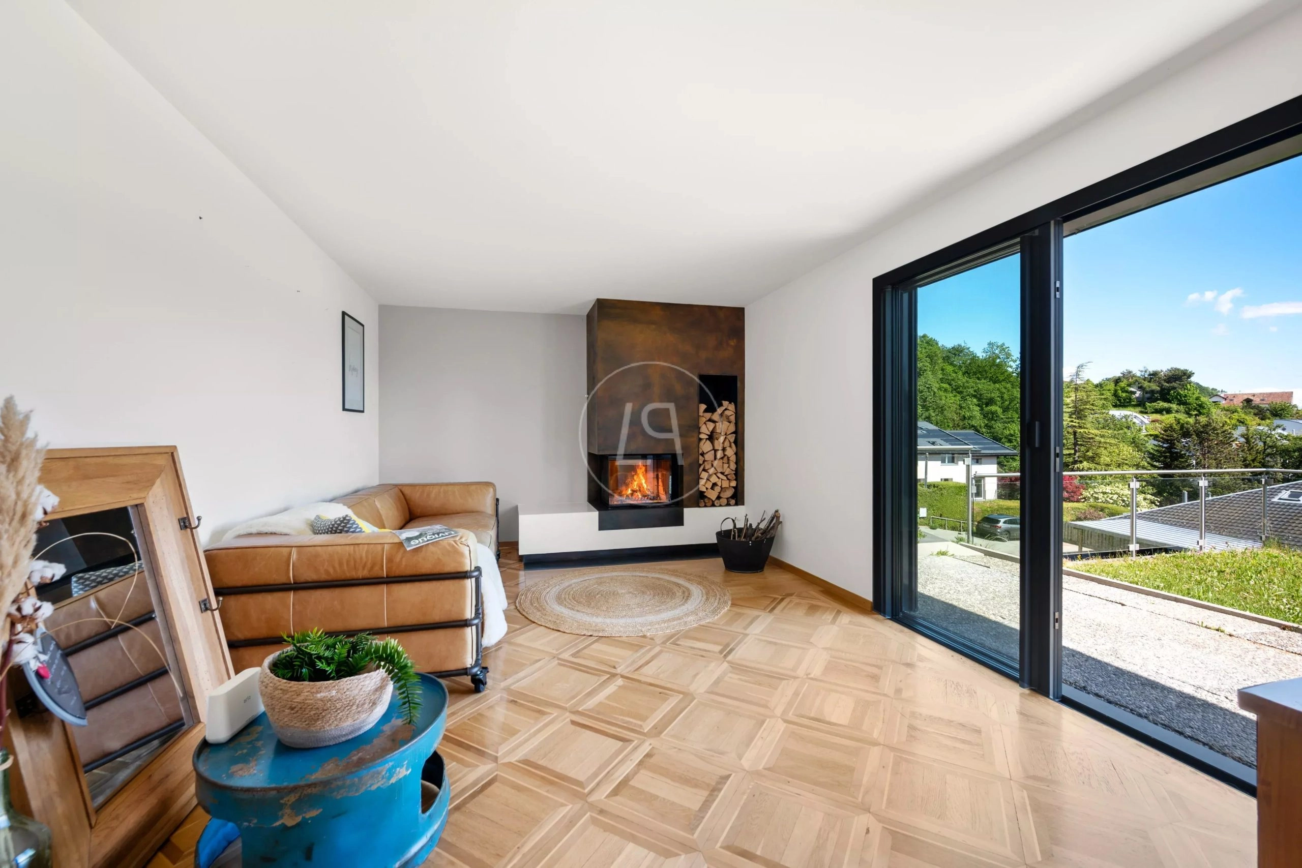 Wohnzimmer mit Kamin und Balkonblick